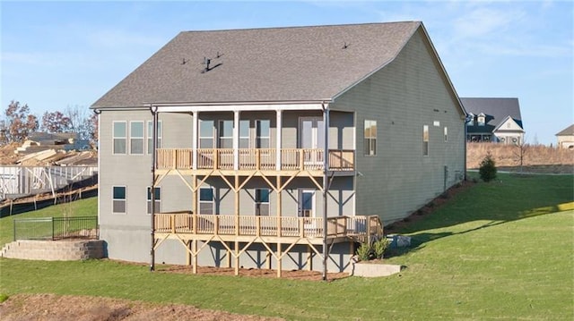 back of house with fence and a yard