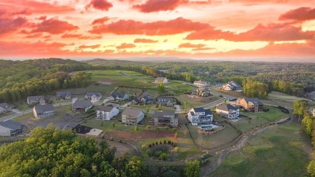 birds eye view of property featuring a wooded view