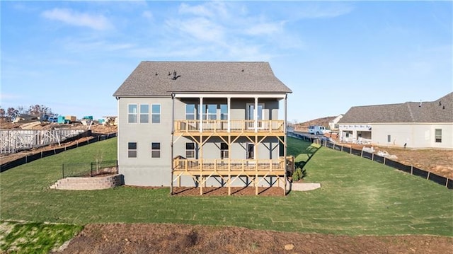 back of house with a lawn, fence, and a wooden deck