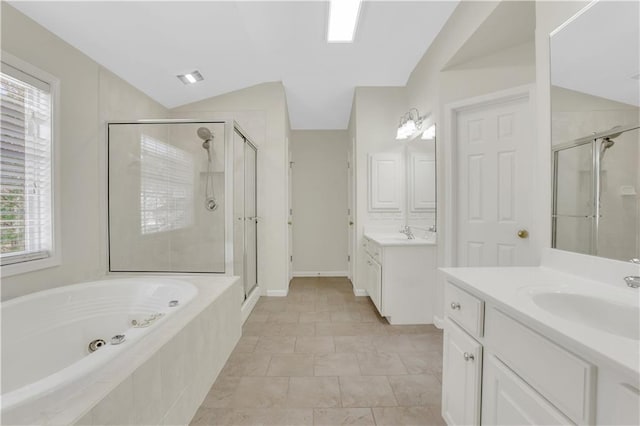 3485 Walnut Rdg, Atlanta, GA 30349 - bathroom featuring lofted ceiling, a stall shower, a garden tub, and two vanities