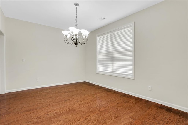 3485 Walnut Rdg, Atlanta, GA 30349 - empty room featuring a chandelier, dark wood-style flooring, and baseboards
