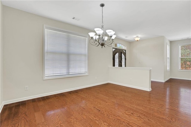 3485 Walnut Rdg, Atlanta, GA 30349 - unfurnished room featuring wood finished floors, a chandelier, and plenty of natural light