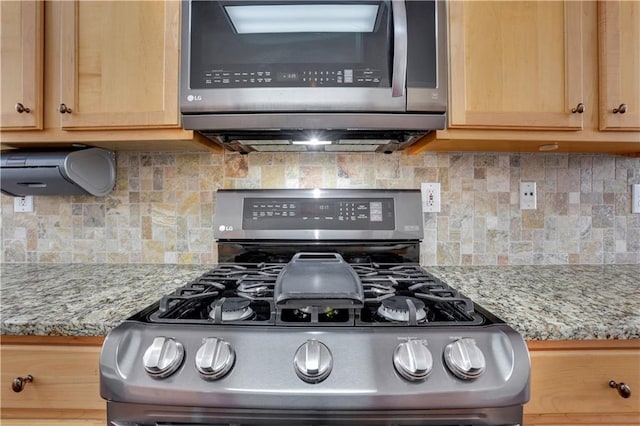 3485 Walnut Rdg, Atlanta, GA 30349 - kitchen view of appliances with stainless steel finishes, light brown cabinetry, backsplash, and light stone counters