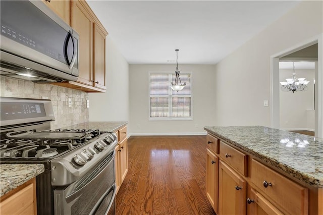 3485 Walnut Rdg, Atlanta, GA 30349 - kitchen with appliances with stainless steel finishes, tasteful backsplash, dark wood finished floors, a chandelier, and baseboards
