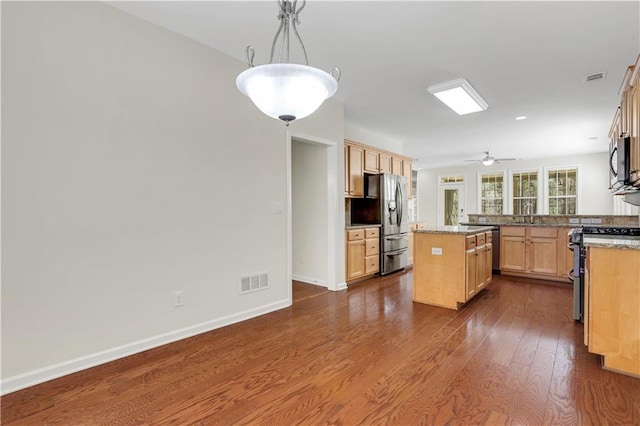3485 Walnut Rdg, Atlanta, GA 30349 - kitchen featuring appliances with stainless steel finishes, dark wood-style flooring, light brown cabinets, and baseboards