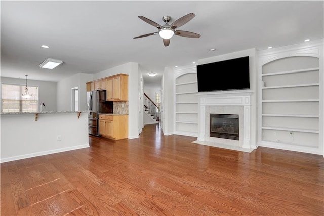 3485 Walnut Rdg, Atlanta, GA 30349 - unfurnished living room with a ceiling fan, baseboards, a tile fireplace, wood finished floors, and stairway