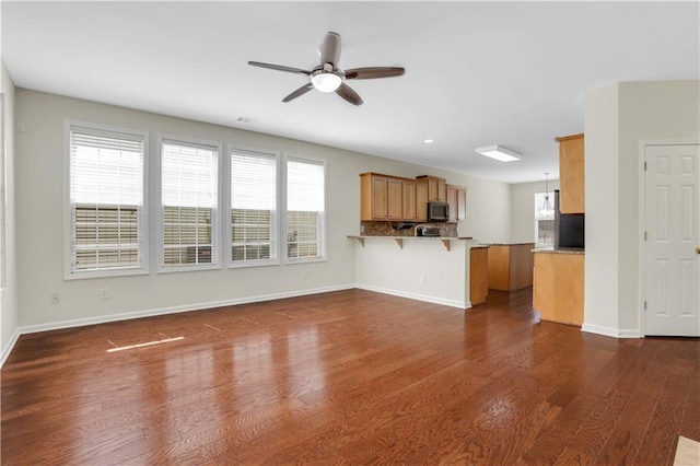 3485 Walnut Rdg, Atlanta, GA 30349 - unfurnished living room with ceiling fan, dark wood finished floors, and baseboards