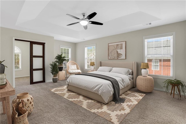 3485 Walnut Rdg, Atlanta, GA 30349 - bedroom with a tray ceiling, carpet, baseboards, and a ceiling fan