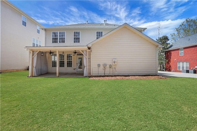 3485 Walnut Rdg, Atlanta, GA 30349 - back of house with ceiling fan, a patio, and a lawn