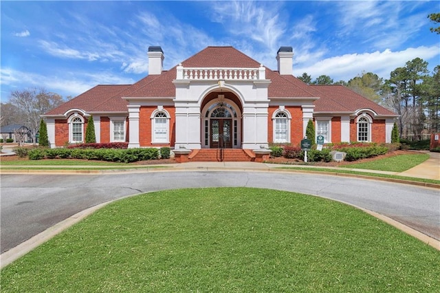 3485 Walnut Rdg, Atlanta, GA 30349 - view of front of property featuring french doors, a front lawn, a chimney, and brick siding