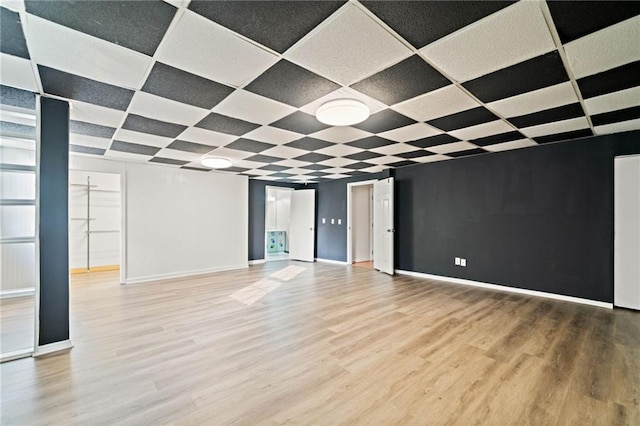 unfurnished living room featuring baseboards and wood finished floors