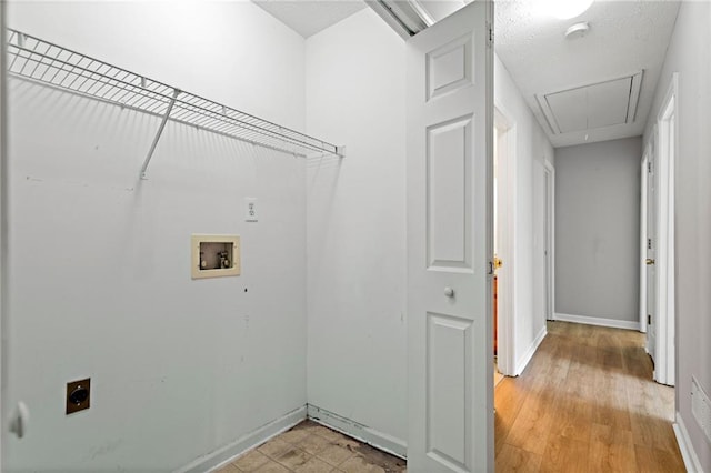 laundry room with laundry area, baseboards, attic access, hookup for a washing machine, and hookup for an electric dryer