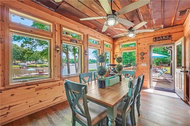 184 Bradley Rd, Jackson, GA 30233 - dining room with wood ceiling, wooden walls, light wood-style flooring, and ceiling fan