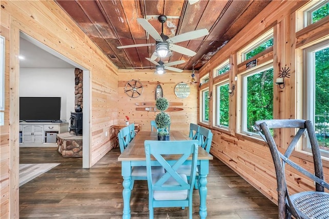 184 Bradley Rd, Jackson, GA 30233 - dining space with wooden ceiling, wood walls, a wood stove, ceiling fan, and wood finished floors