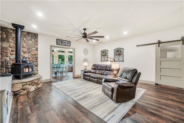 184 Bradley Rd, Jackson, GA 30233 - living area featuring a barn door, ceiling fan, a wood stove, recessed lighting, and wood-type flooring