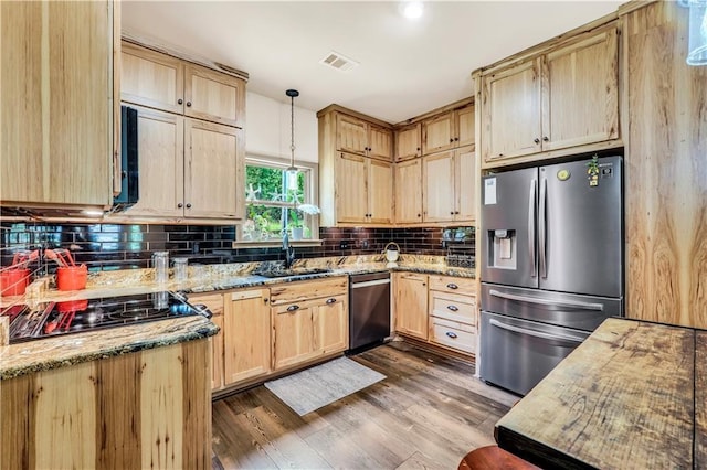 184 Bradley Rd, Jackson, GA 30233 - kitchen with appliances with stainless steel finishes, light brown cabinetry, a sink, tasteful backsplash, and light stone counters