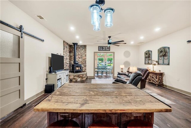 184 Bradley Rd, Jackson, GA 30233 - dining space featuring a wood stove, ceiling fan, dark wood-style flooring, baseboards, and recessed lighting