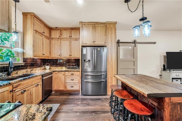 184 Bradley Rd, Jackson, GA 30233 - kitchen with stainless steel appliances, a barn door, a sink, light brown cabinetry, and dark wood finished floors