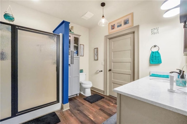 184 Bradley Rd, Jackson, GA 30233 - full bathroom with wood finished floors, vanity, a stall shower, and toilet