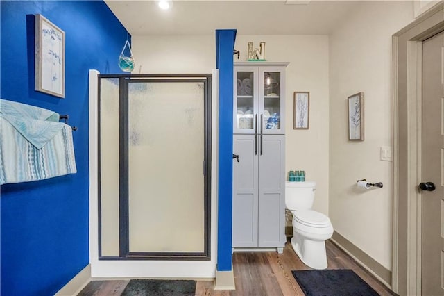 184 Bradley Rd, Jackson, GA 30233 - full bathroom with wood finished floors, toilet, and a stall shower