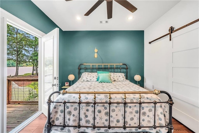 184 Bradley Rd, Jackson, GA 30233 - bedroom featuring wood finished floors, a barn door, ceiling fan, and recessed lighting
