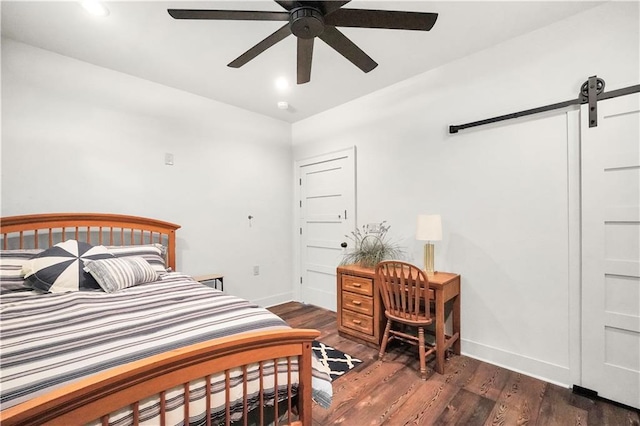 184 Bradley Rd, Jackson, GA 30233 - bedroom with a barn door, baseboards, and wood finished floors
