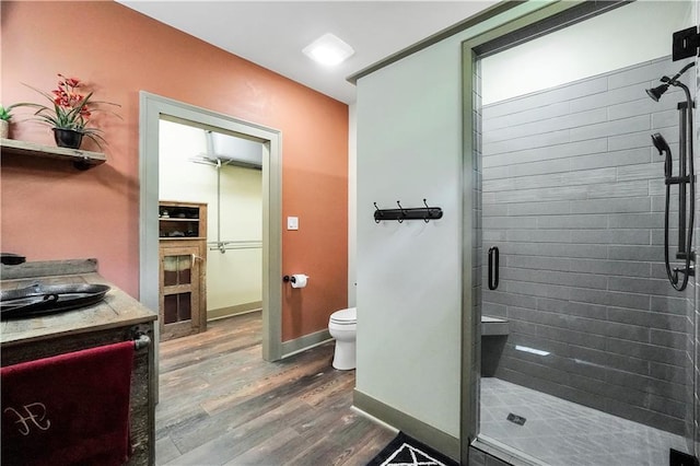 184 Bradley Rd, Jackson, GA 30233 - bathroom with toilet, a stall shower, wood finished floors, vanity, and baseboards