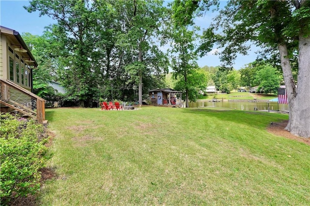 184 Bradley Rd, Jackson, GA 30233 - view of grassy yard with a water view, an outbuilding, and view of scattered trees