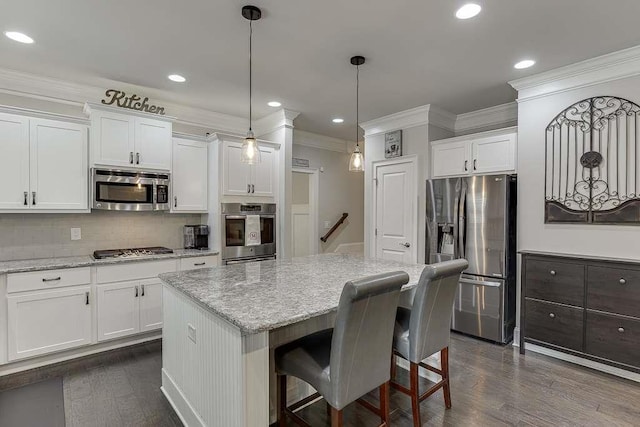 470 Wagon Hill Ln, Sugar Hill, GA 30518 - kitchen with stainless steel appliances, crown molding, tasteful backsplash, white cabinets, and a center island