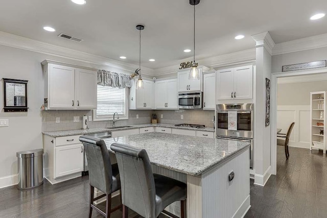 470 Wagon Hill Ln, Sugar Hill, GA 30518 - kitchen with stainless steel appliances, white cabinetry, a center island, dark wood-style flooring, and backsplash