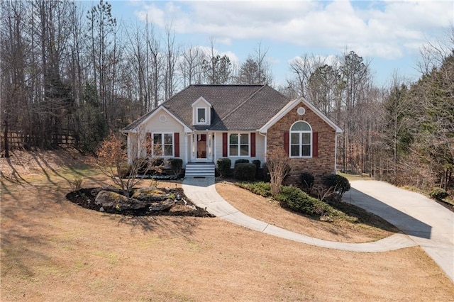 view of front of home featuring a shingled roof, driveway, and crawl space