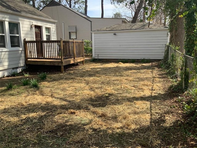 view of yard featuring an outdoor structure and a deck