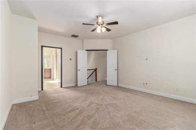 6023 Brookside Oak Cir, Norcross, GA 30093 - unfurnished bedroom with light carpet, baseboards, ensuite bath, and a ceiling fan