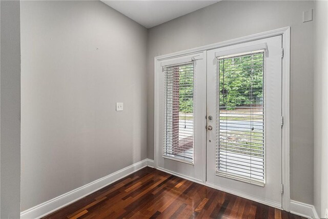 6023 Brookside Oak Cir, Norcross, GA 30093 - living area with a towering ceiling, a lit fireplace, dark wood-style floors, and baseboards
