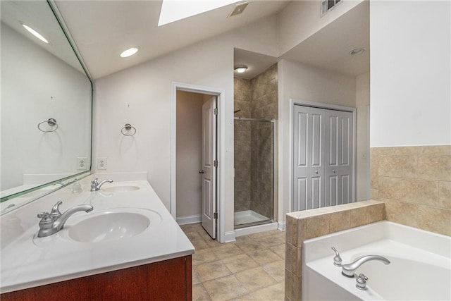 6023 Brookside Oak Cir, Norcross, GA 30093 - bathroom with a shower stall, a bath, a skylight, double vanity, and vaulted ceiling