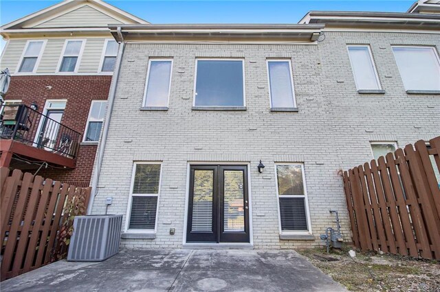 6023 Brookside Oak Cir, Norcross, GA 30093 - rear view of house with brick siding, central AC unit, fence, and a patio