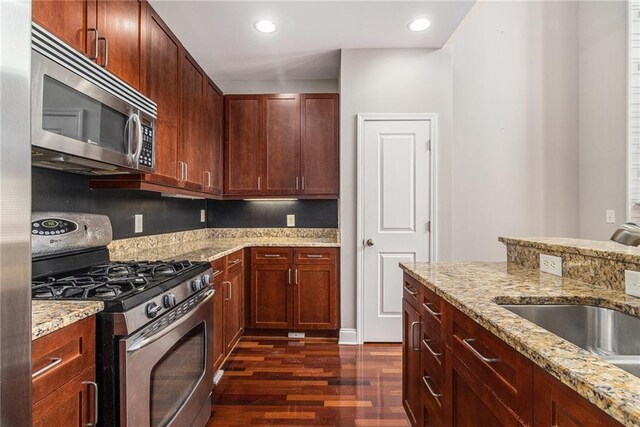 6023 Brookside Oak Cir, Norcross, GA 30093 - living room with a towering ceiling, stairs, dark wood-style floors, a warm lit fireplace, and baseboards