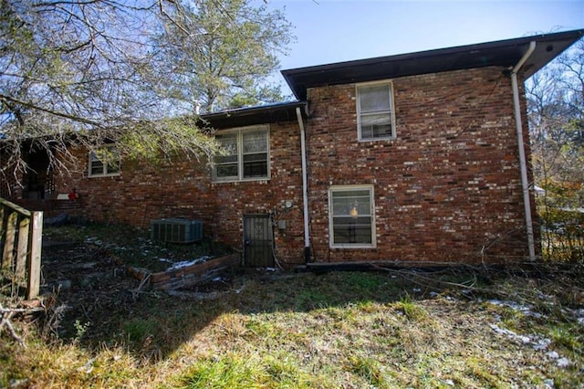 back of property featuring central AC