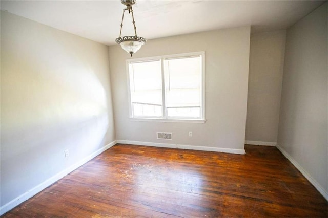 unfurnished room featuring dark hardwood / wood-style floors