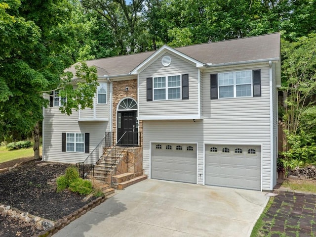 2623 Lone Oak Trl NW, Kennesaw, GA 30144 - bi-level home featuring an attached garage, concrete driveway, and view of wooded area
