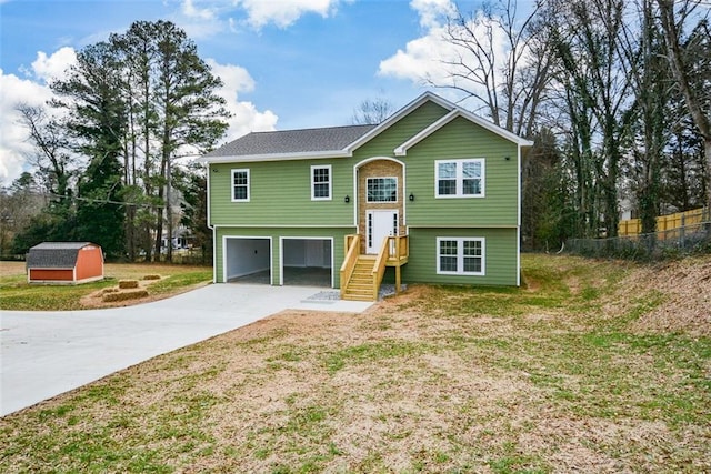 split foyer home with a garage and a front lawn