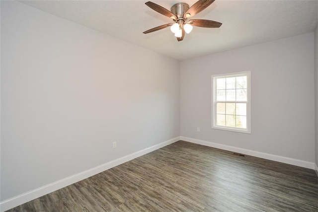 spare room with ceiling fan and dark hardwood / wood-style flooring