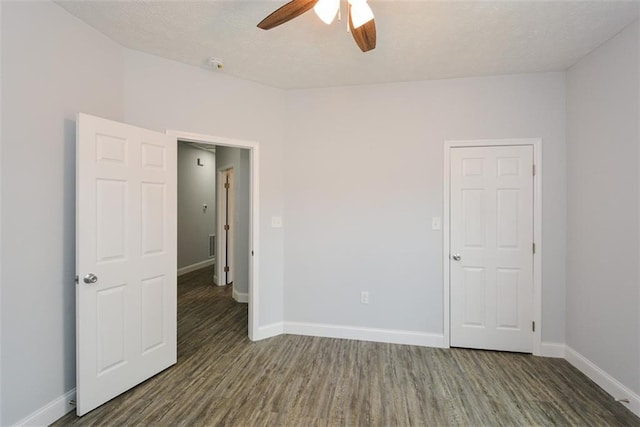 spare room with ceiling fan and dark hardwood / wood-style flooring