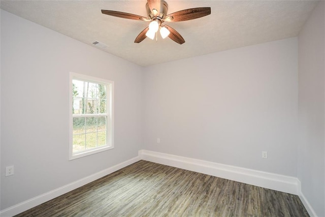 spare room with ceiling fan and dark hardwood / wood-style flooring