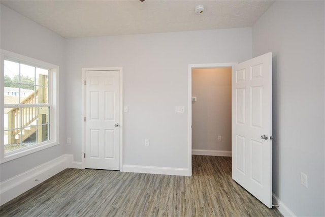 unfurnished bedroom with hardwood / wood-style floors