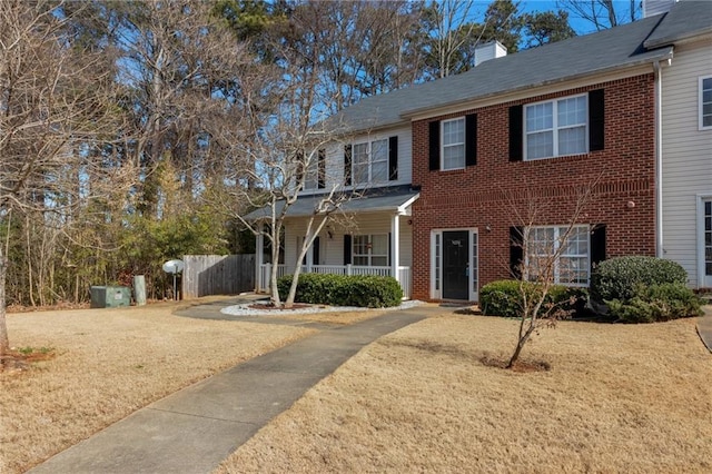 5090 Leeshire Trce, Tucker, GA 30084 - view of front facade featuring brick siding, a chimney, and a porch
