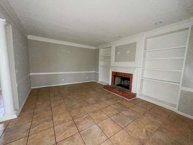 unfurnished living room with tile patterned floors, baseboards, ornamental molding, a fireplace, and built in features