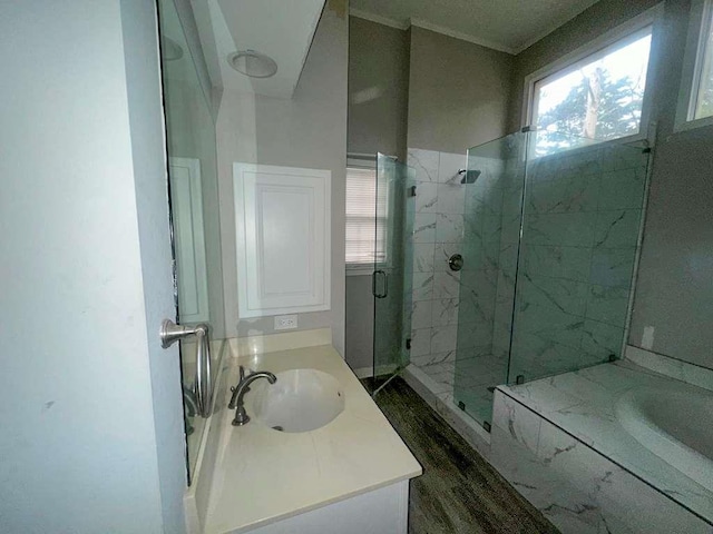 full bathroom featuring a wealth of natural light, a marble finish shower, a bath, and vanity