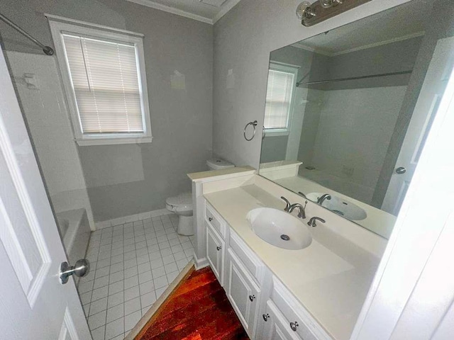 full bathroom with tile patterned flooring, toilet, vanity, baseboards, and crown molding