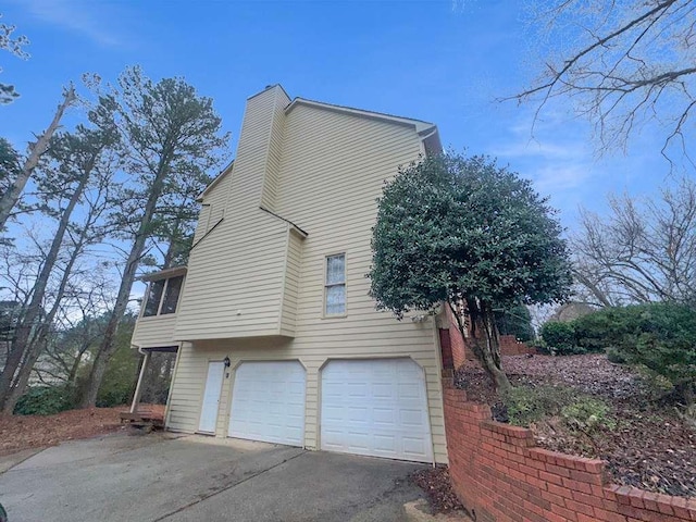 view of home's exterior with a garage and aphalt driveway